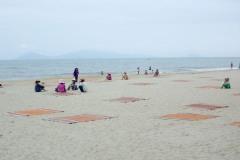 Locals relaxing at Cua Dai Beach