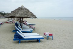 long chairs and umbrellas on Cua Dai Beach